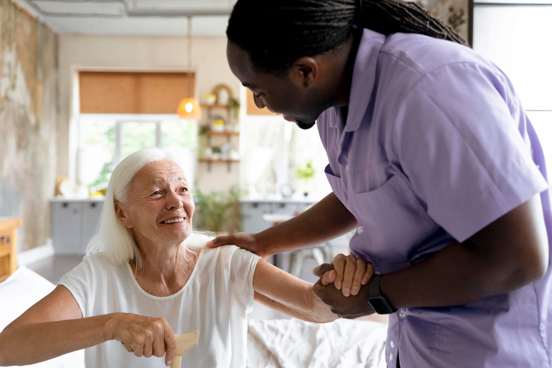 Carer supporting an older woman